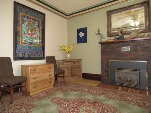 a living room with a fireplace and a mirror at Downtown Bed and Breakfast in Ottawa