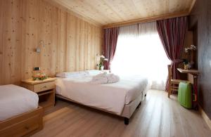 Postel nebo postele na pokoji v ubytování Hotel Funivia