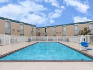 a swimming pool in front of a building at SureStay Hotel by Best Western Duncan in Duncan