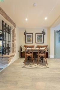 a dining room with two chairs and a table at The Old Mill Inn in Dearham