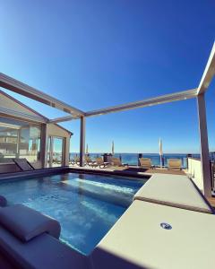a swimming pool with a view of the ocean at Hotel Villa Letizia in Bardolino