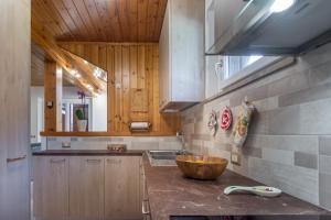 a kitchen with a counter with a bowl on it at DolomiApartments - Casa Lagorai in Predazzo +10 photos