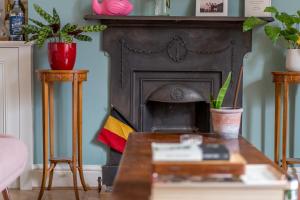 a living room with a fireplace and a table at ALTIDO Eclectic flat with Garden in London