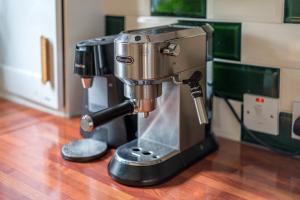 a mixer sitting on top of a wooden floor at ALTIDO Eclectic flat with Garden in London