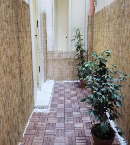 a hallway with plants and a brick floor at La Casa di Dani e Marco vicino Ortigia, Siracusa in Siracusa