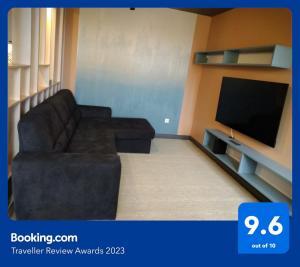 a living room with a couch and a flat screen tv at Blonde River Apartman Móra Szeged in Szeged