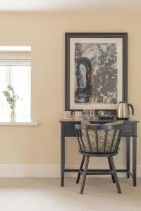 a black desk with a chair in a room at The Old Mill Inn in Dearham
