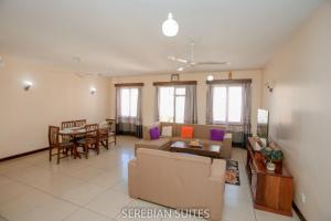 a living room with a couch and a table at Serebian Suites in Mombasa
