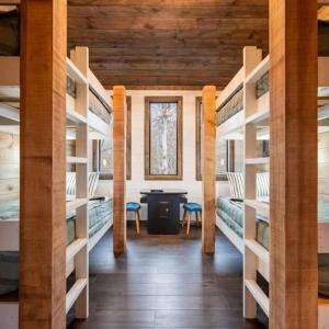 a room with multiple bunk beds and a desk at Haven Hideaway, New Luxury Cabin w/ hot tub and fire pit in Broken Bow