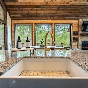 a kitchen with a sink and a counter top at Haven Hideaway, New Luxury Cabin w/ hot tub and fire pit in Broken Bow