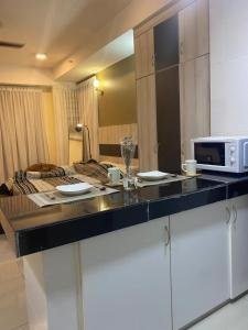 a kitchen with a counter with a microwave on it at The Sugar'Barn Studio D Perdana kota bharu in Kota Bharu