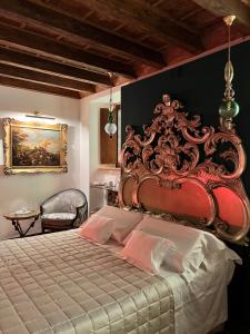 a bedroom with a large bed with a red headboard at Marcello Sleep&Spa in Verona