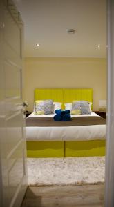 a bedroom with a large bed with a yellow headboard at Tu Guesthouse in Stanley
