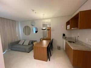 a kitchen and living room with a couch and a table at Salinas Exclusive Resort in Salinópolis