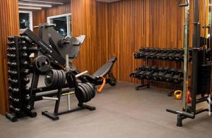 a gym with dumbbells and other equipment in a room at Salinas Exclusive Resort in Salinópolis