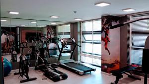 a gym with tread machines and a mirror at Apartamento cómodo y espectacular en Concón !! in Concón
