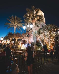 a group of people standing in front of a building with palm trees at Luxurious apartment in Puerto Banus Marbella in Marbella