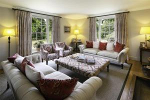 a living room with couches and a coffee table at Butley Priory Farmhouse in Woodbridge