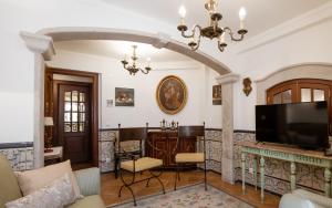 a living room with a fireplace and a tv at Casa de S. Thiago de Obidos in Óbidos