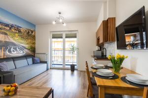 a living room with a couch and a table at Apartament 66 Zator in Zator