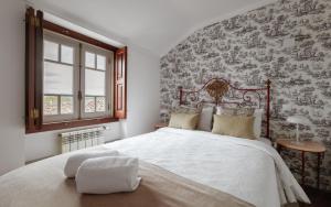 Cama ou camas em um quarto em Casa de S. Thiago de Obidos