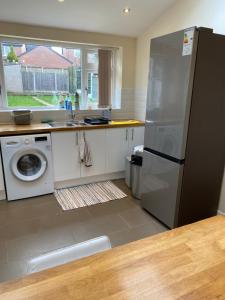 a kitchen with a stainless steel refrigerator and a dishwasher at Greenwood in Manchester