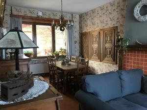 a living room with a blue couch and a table at Les colombages in Dinant