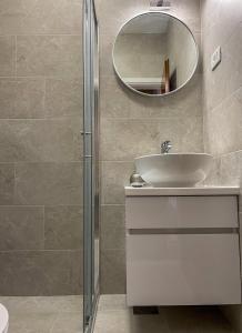 a bathroom with a sink and a mirror at Apartments Marija Magdalena in Hvar