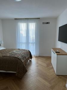 a bedroom with a bed and a flat screen tv at Villa Relax in Stresa +22 photos