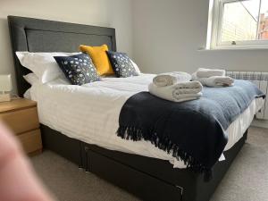 a bedroom with a bed with towels on it at Impeccable 1-Bed Apartment in Ulverston in Ulverston