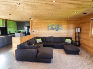 a living room with a couch and a kitchen at iLodge Ultra in Louth