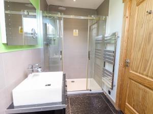 a bathroom with a shower and a white sink at iLodge Ultra in Louth +27 photos