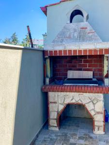 an outdoor brick oven on the side of a house at Neroli Apartments in Nikiti