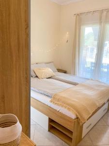 a bedroom with a large bed with a window at Neroli Apartments in Nikiti