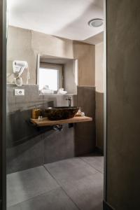 a bathroom with a sink and a mirror at Pendino Luxury Rooms in Naples