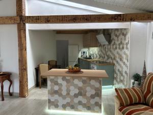 a living room with a kitchen and a table in a room at Casa La Oliva in Garachico