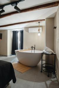 a large bath tub sitting in a room at Pendino Luxury Rooms in Naples
