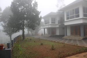 a house on a foggy street in front of a house at The Lavender Woods in Vythiri +13 photos