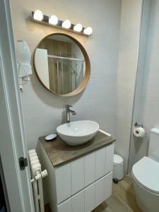 a bathroom with a sink and a mirror at Hotel La Bilbaina de Vegadeo in Vegadeo