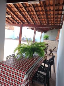 a table with a plaid table cloth on a patio at RECANTO DAS ARARAS in Olímpia