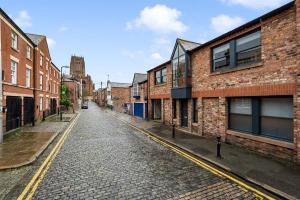 an empty street in an old city with brick buildings at Host & Stay - The Coachouse at Pilgrim St in Liverpool