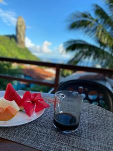 une assiette de nourriture et un verre de vin sur une table dans l'établissement Pousada Aratu, à Fernando de Noronha