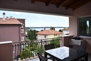 a balcony with a table and a view of the water at Apartment Angela in Portorož