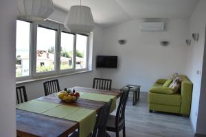 a living room with a table and a couch at Apartment Angela in Portorož