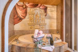 a bathroom with a tub and a sink and a bath tub at Haus Sonnenhang Wohnung 1 in Stiefenhofen +24 photos
