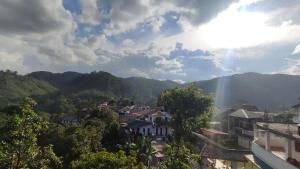 a view of a city with mountains in the background at Foggy Mount View in Bandarawela +47 photos
