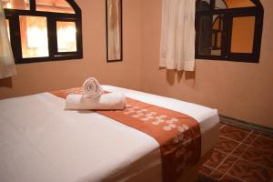 a bedroom with a bed with a towel on it at Casa del Mar by Playa Larga in Agua de Correa