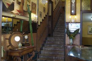 a spiral staircase in a building with a stair case at Hotel Touring in Messina