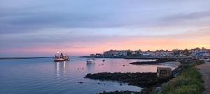 two boats in a body of water at sunset at La casita de la punta in Isla del Moral
