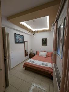 a bedroom with a bed and a skylight at Kouriton apartment is an ideal place to relax in Gouves